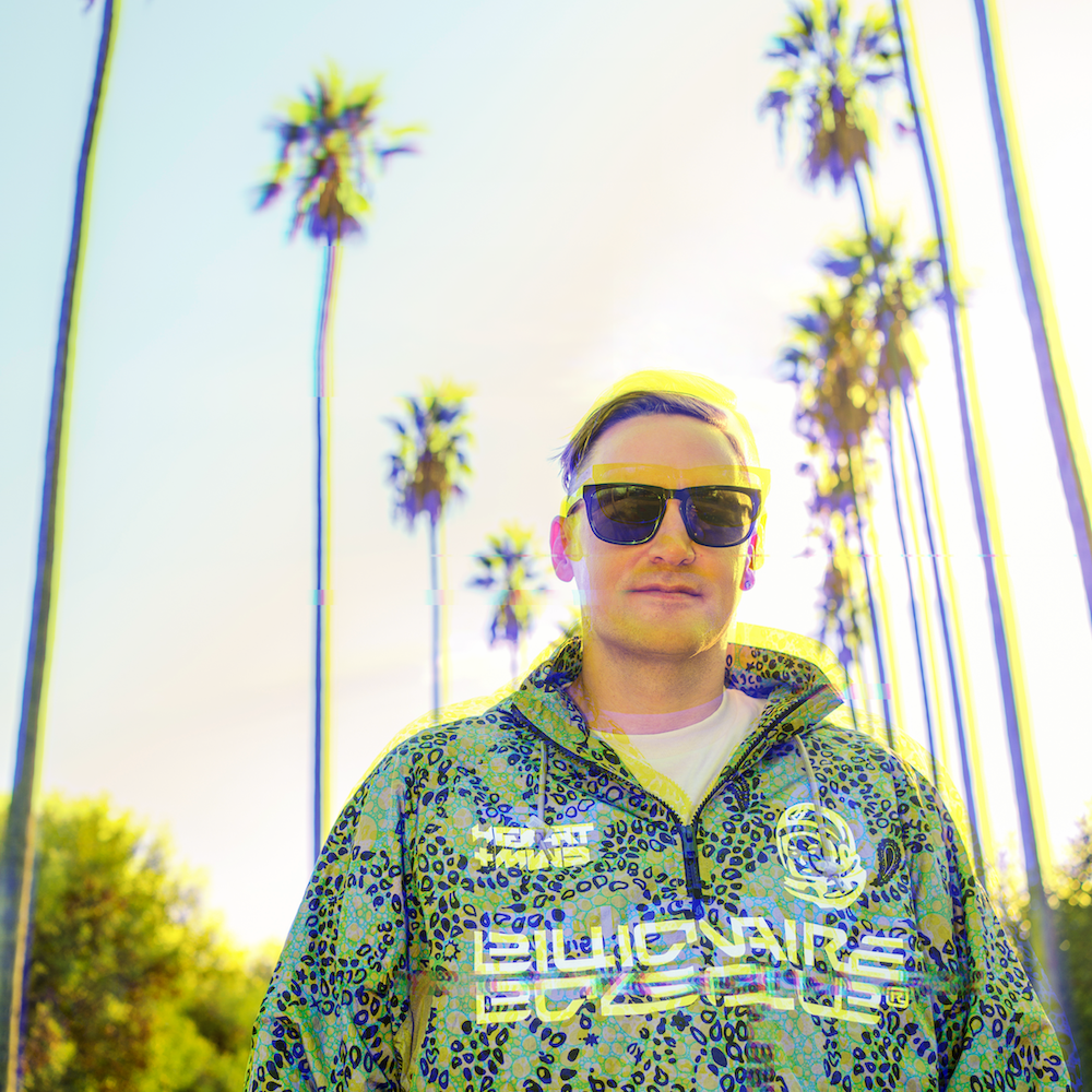 Jonathan Christiansen wearing sunglasses beneath Los Angeles palms